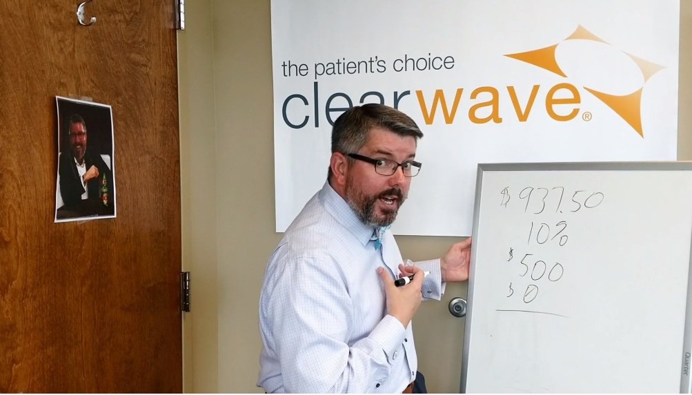 Eric Anderson explaining math equation on a white board