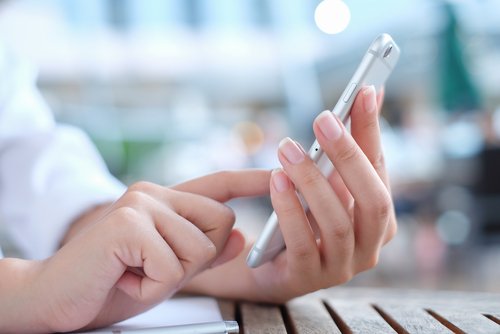 Close-Up of Hands Using Mobile Phone