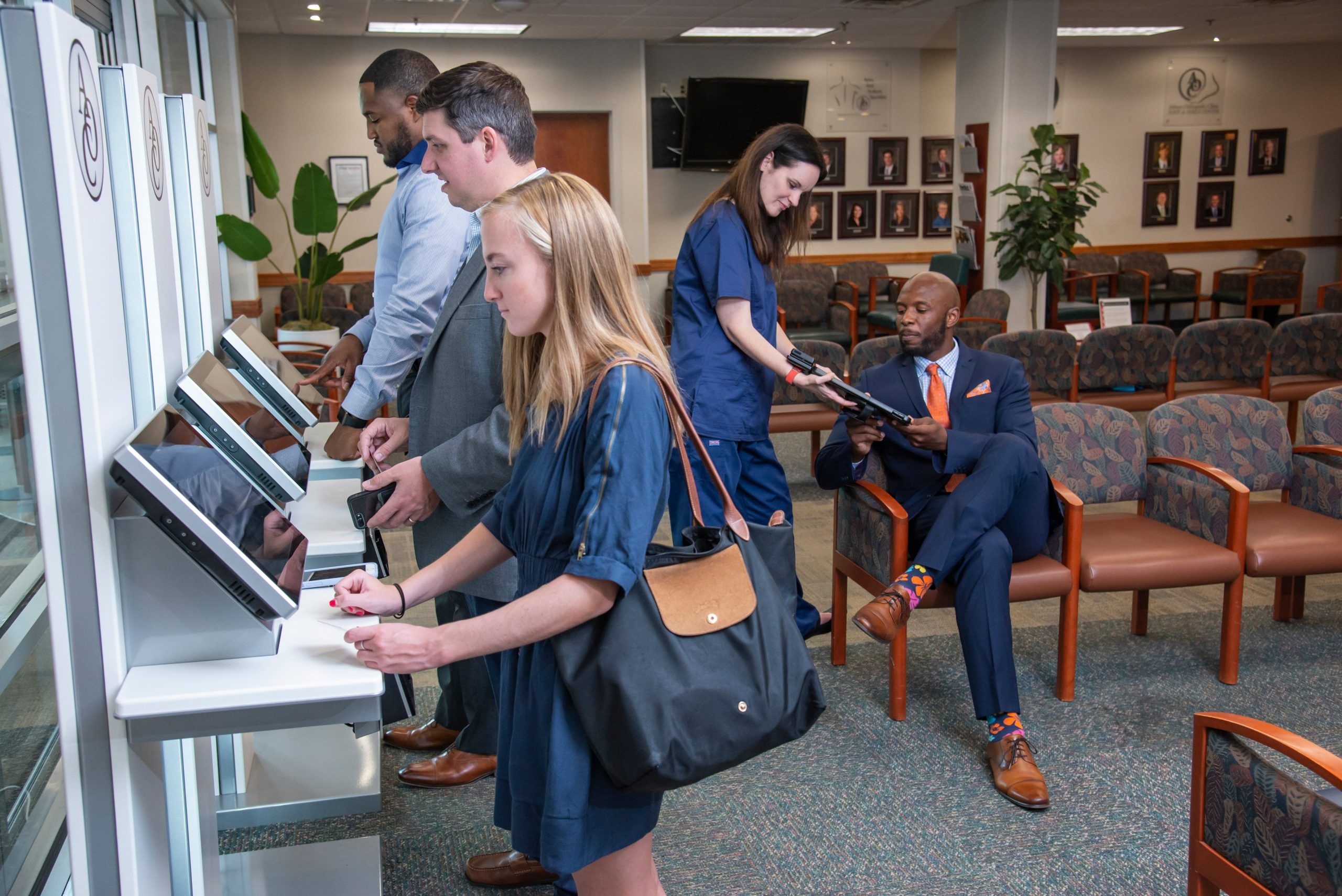 Patients using Clearwave Connect tablets to check in