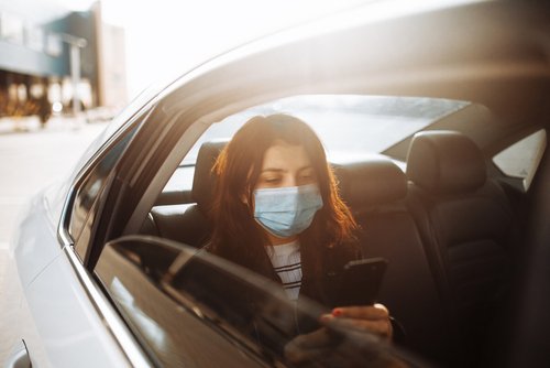 Woman wearing mask in car 