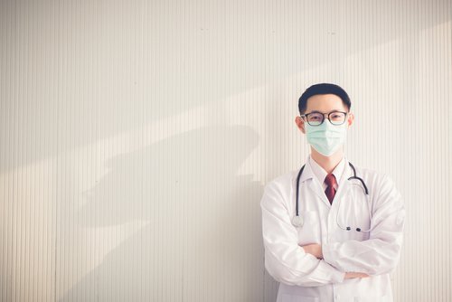 man standing in front of wall with mask on 