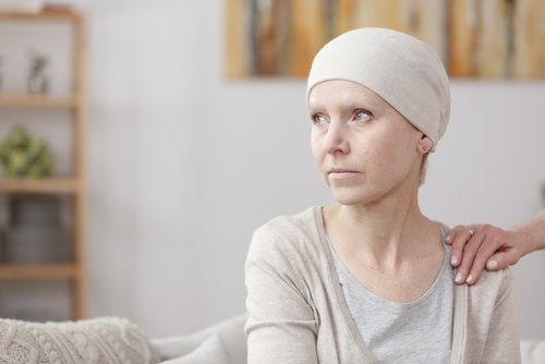 woman with cancer sitting on couch