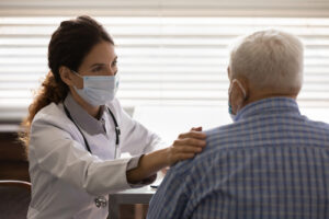 Doctor treating patient while masked